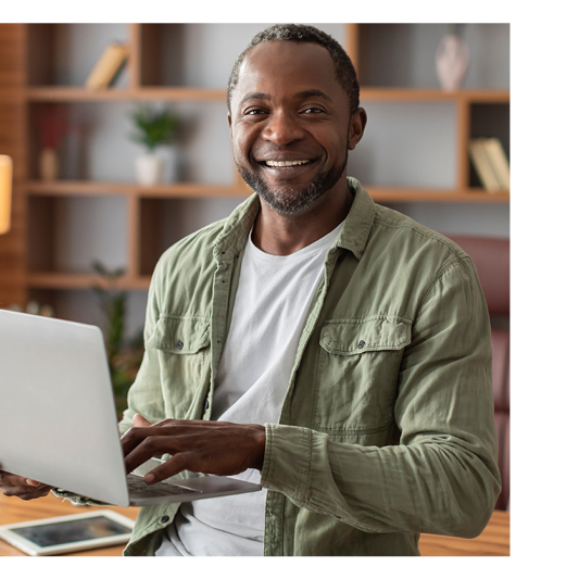 smiling man with laptop