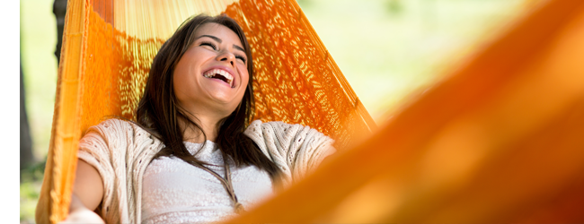 woman relaxing in orange hammock