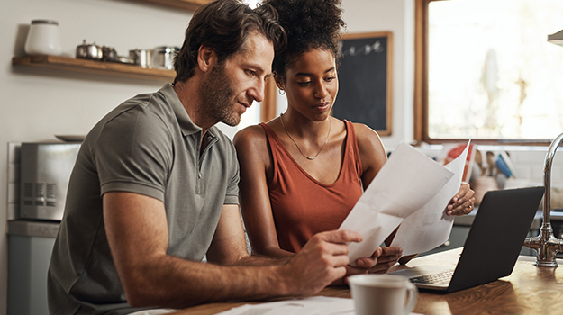 couple looking at paperwork in kitchen