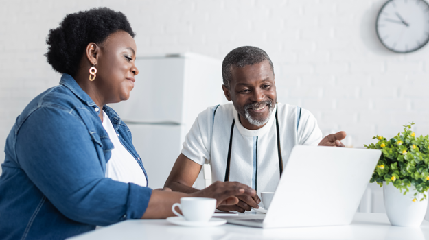couple looking at at laptop at table